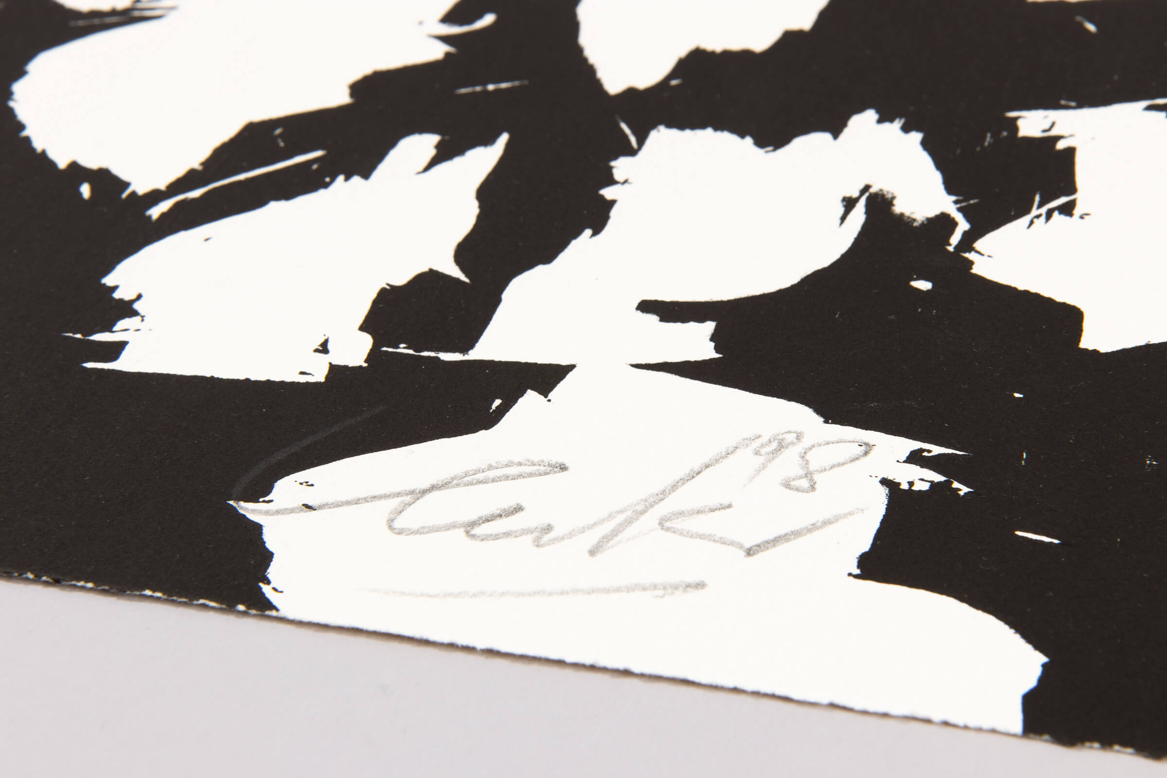 Black and white abstract art with a signature in the center