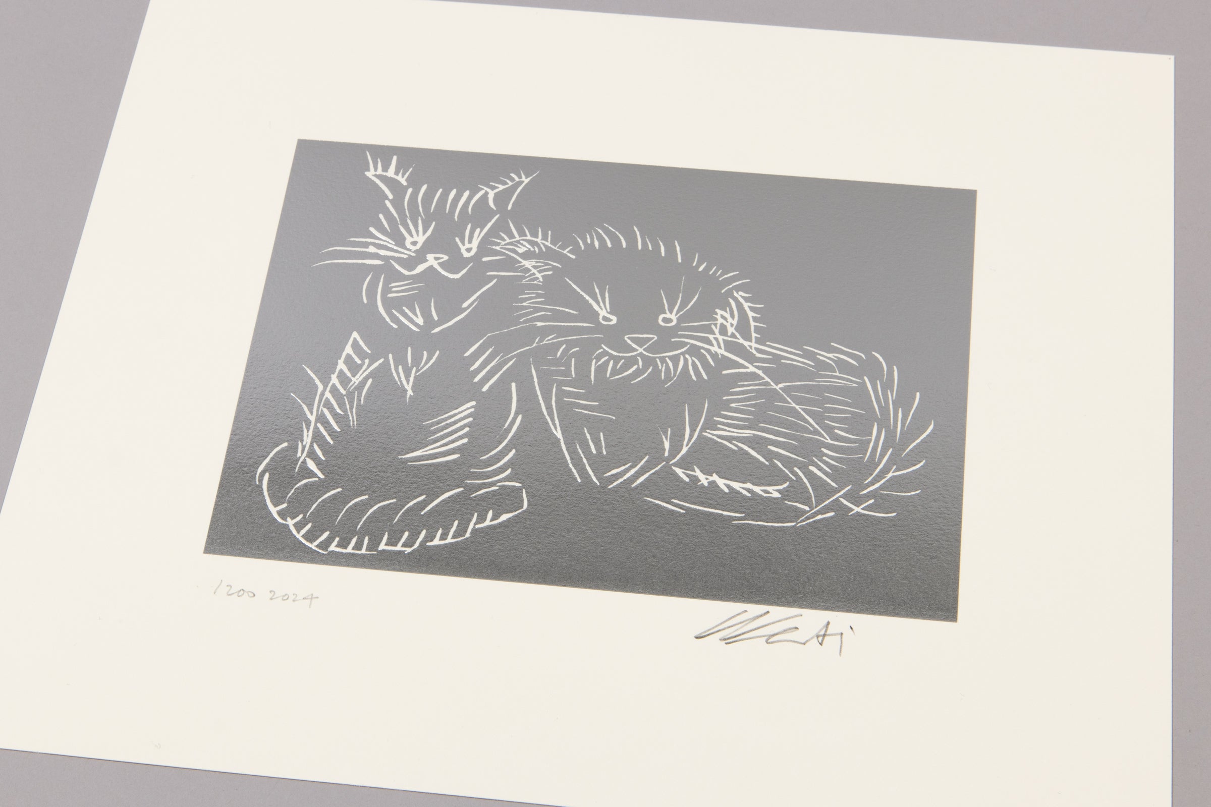 Ai Weiwei's depiction of a cat on a silver background with a signature at the bottom right corner.