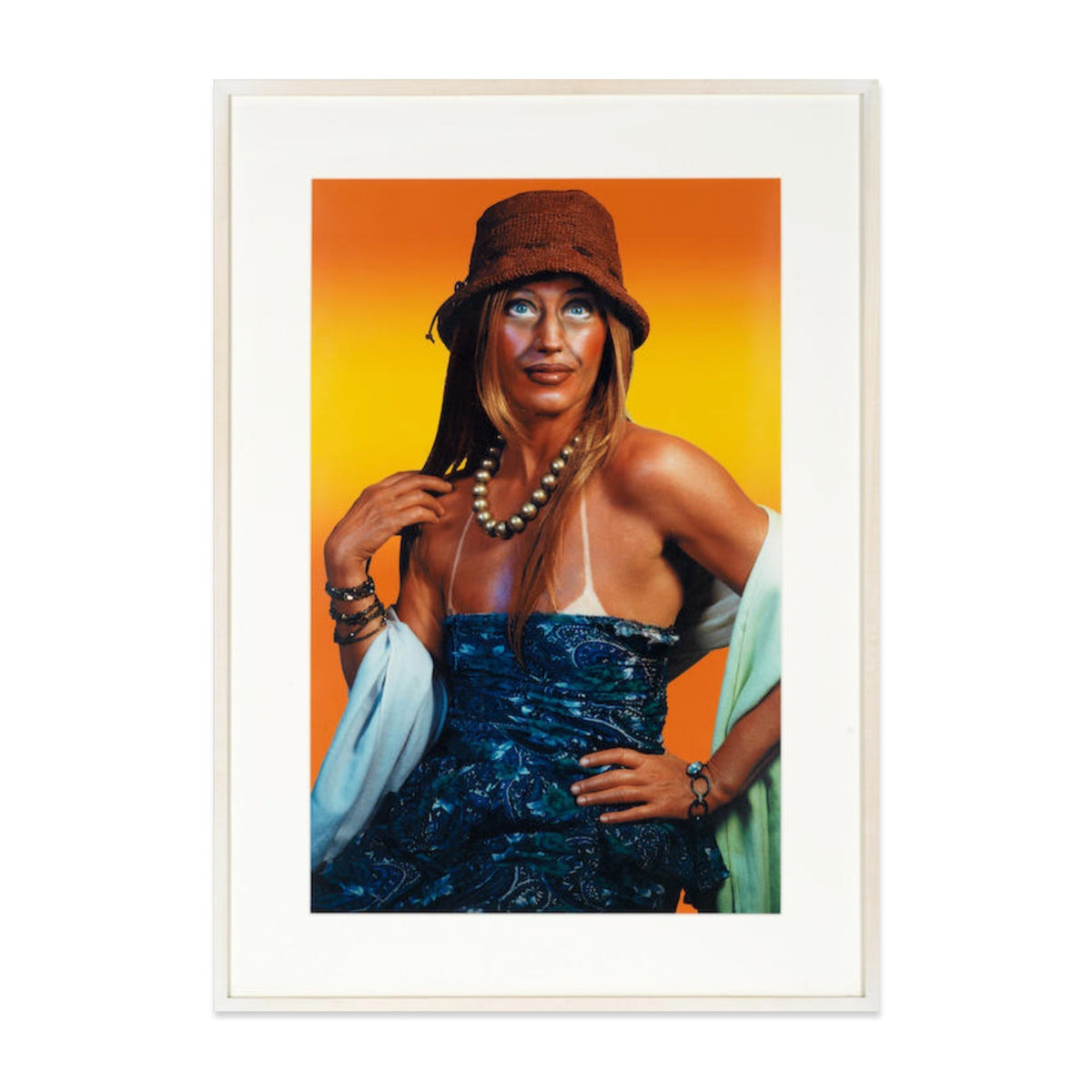 Cindy Sherman print featuring a staged portrait of a woman in a hat and sunglasses against a warm gradient background